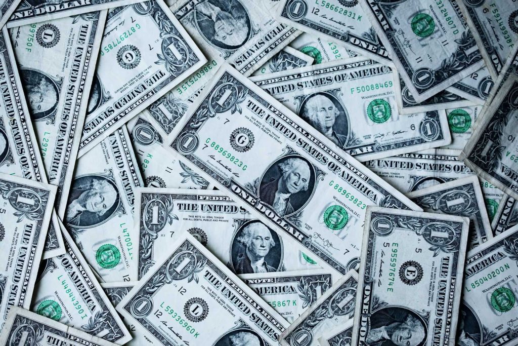 Close-up of US $1 bills in a pile
