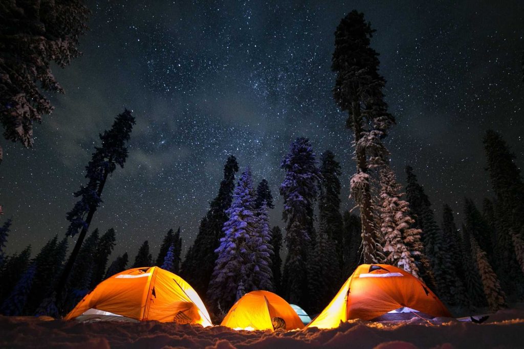 three tents under the night sky