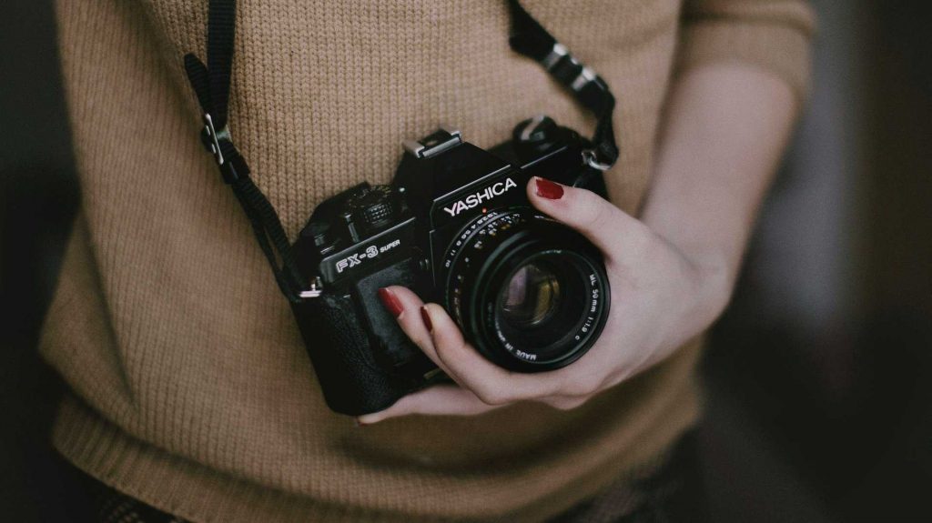 freelance photographer holding a camera