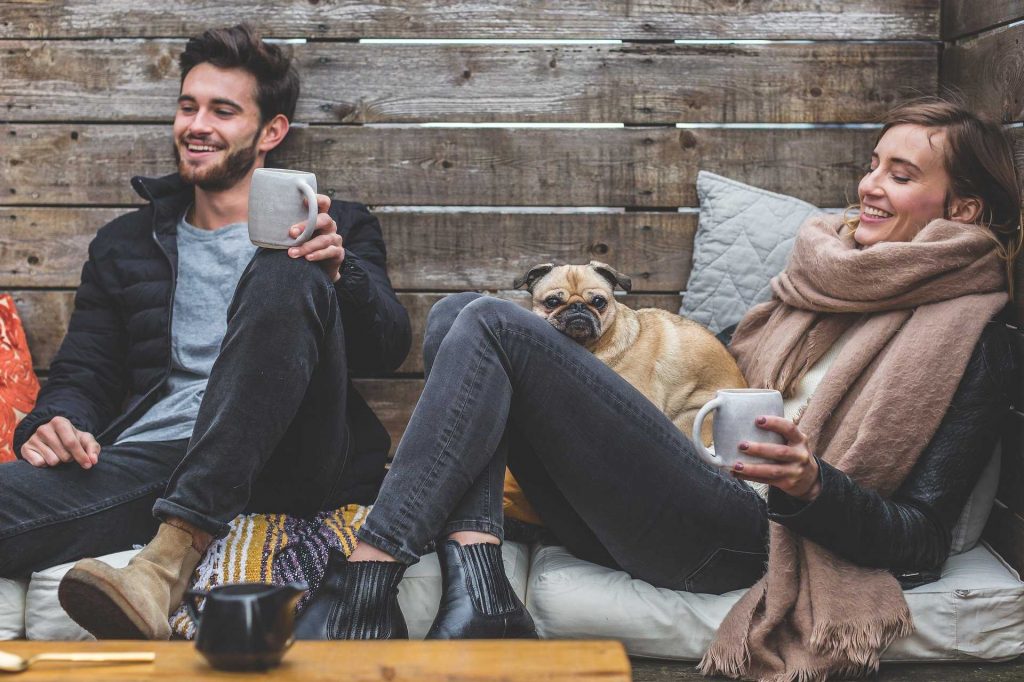 young couple relaxing with a dog