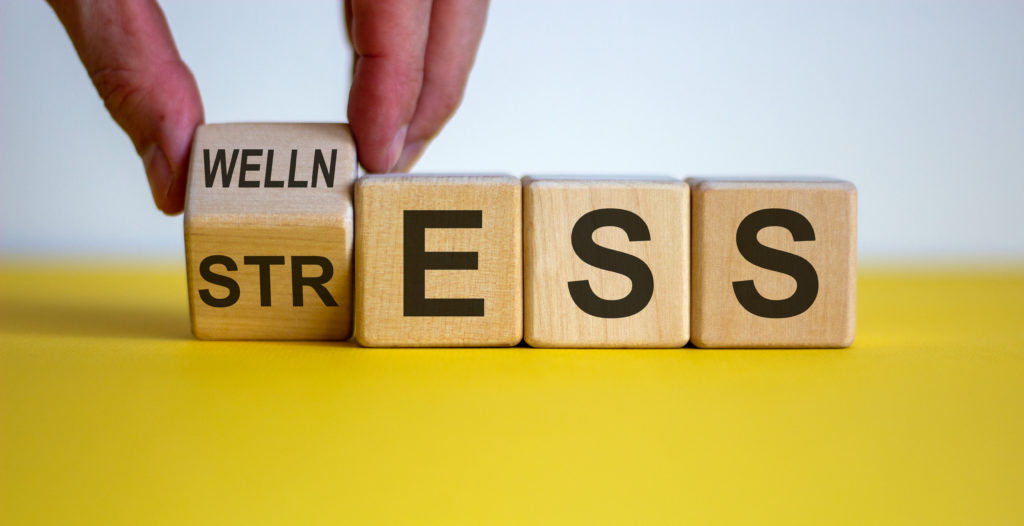 wooden blocks of stress turning into wellness